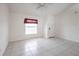 A well-lit living room with tile flooring, a ceiling fan, and a large window at 3436 Discovery Dr, Punta Gorda, FL 33983