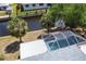 An aerial view of a screened in pool adjacent to a canal in the backyard at 3436 Discovery Dr, Punta Gorda, FL 33983