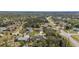 A neighborhood aerial reveals a variety of homes surrounded by lush landscaping, under a bright sky, offering a peaceful setting at 3956 Fairchild Ave, North Port, FL 34287