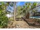 A peaceful backyard features lush greenery and access to a screened-in pool at 3956 Fairchild Ave, North Port, FL 34287