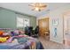 Bright bedroom features a ceiling fan, window, closet, decorative 'G', and wood floors at 3956 Fairchild Ave, North Port, FL 34287