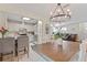 Open-concept dining area with stainless steel appliances, a pendant light, and a view to the living room at 3956 Fairchild Ave, North Port, FL 34287