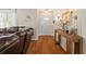 Bright entryway with hardwood floors, console table, and wall sconces that welcomes you inside at 3956 Fairchild Ave, North Port, FL 34287