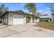 Home featuring a garage and nice lawn, offering great curb appeal in a residential setting at 3956 Fairchild Ave, North Port, FL 34287