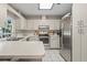 Bright kitchen with stainless steel appliances, white cabinets, and a skylight for natural light at 3956 Fairchild Ave, North Port, FL 34287