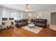 Spacious living room with hardwood floors, a ceiling fan, and a comfortable seating area at 3956 Fairchild Ave, North Port, FL 34287