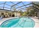 Screened-in pool area with sparkling water, a spa, and plenty of space for relaxation at 3956 Fairchild Ave, North Port, FL 34287