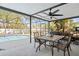 Covered patio area with outdoor dining set overlooking a sparkling pool at 3956 Fairchild Ave, North Port, FL 34287