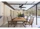 Covered patio featuring a dining set, ceiling fan, and a view of the pool at 3956 Fairchild Ave, North Port, FL 34287
