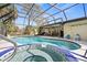 Inviting screened-in pool with a spa and outdoor seating area for entertaining at 3956 Fairchild Ave, North Port, FL 34287