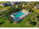 Aerial view of the community pool featuring lush tropical landscaping at 4000 Bal Harbor Blvd # 124, Punta Gorda, FL 33950