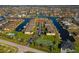 Aerial view of a condo community surrounded by canals, featuring community tennis courts at 4000 Bal Harbor Blvd # 217, Punta Gorda, FL 33950