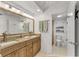 Bathroom featuring granite countertops, double sinks, decorative sconces, and tiled floors at 4000 Bal Harbor Blvd # 217, Punta Gorda, FL 33950