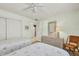 Charming twin bedroom featuring soft green walls, quaint nautical decor, and a view to the hallway and closets at 4000 Bal Harbor Blvd # 217, Punta Gorda, FL 33950