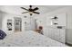 Neutral bedroom featuring plantation shutters, ensuite bath, and a view through to a large closet at 4000 Bal Harbor Blvd # 217, Punta Gorda, FL 33950