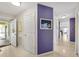 Hallway with tile floors, colorful wall art, and view of the unit's entry and interior at 4000 Bal Harbor Blvd # 217, Punta Gorda, FL 33950