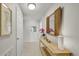 Hallway featuring tile floors, a wooden console table with mirror, and decorative art at 4000 Bal Harbor Blvd # 217, Punta Gorda, FL 33950