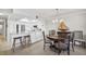 Modern white kitchen featuring stainless appliances, breakfast bar, and an adjacent dining area at 4000 Bal Harbor Blvd # 217, Punta Gorda, FL 33950