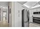 Updated kitchen with stainless steel appliances and white cabinetry, next to a hallway at 4000 Bal Harbor Blvd # 217, Punta Gorda, FL 33950