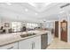 Bright, open kitchen with granite countertops, stainless steel appliances, and views of the living area and backyard at 4000 Bal Harbor Blvd # 217, Punta Gorda, FL 33950