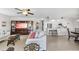 Open-concept living area leading into a white kitchen with granite countertops and counter seating at 4000 Bal Harbor Blvd # 217, Punta Gorda, FL 33950