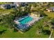 Aerial view of the community pool, surrounded by lush landscaping and lounge chairs at 4000 Bal Harbor Blvd # 217, Punta Gorda, FL 33950
