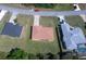Aerial view of a home with a brown roof and driveway, nestled between neighboring houses at 4237 Irdell Ter, North Port, FL 34288