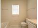 Bathroom featuring a toilet, window and bathtub at 4237 Irdell Ter, North Port, FL 34288