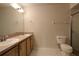 Bathroom features a double sink vanity and a toilet, all in a well-lit space at 4237 Irdell Ter, North Port, FL 34288