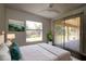 Bedroom featuring sliding glass doors to the porch, wood-look floors, a ceiling fan and an outside view at 4237 Irdell Ter, North Port, FL 34288