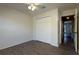 Empty bedroom featuring a light ceiling fan, closet with folding doors and a hardwood floor at 4237 Irdell Ter, North Port, FL 34288