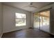 Bedroom featuring sliding glass doors to the porch with wood-look floors and a ceiling fan at 4237 Irdell Ter, North Port, FL 34288