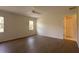 Bright bedroom features wood-look floors, ceiling fan, and natural light from two windows at 4237 Irdell Ter, North Port, FL 34288