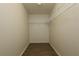 Walk-in closet with open shelving and wood-look floor, ready for organization at 4237 Irdell Ter, North Port, FL 34288