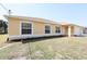 Inviting single-story home with tan siding, white trim, and a well-manicured lawn at 4237 Irdell Ter, North Port, FL 34288