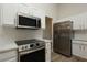 Modern kitchen with stainless steel appliances and white cabinets at 4237 Irdell Ter, North Port, FL 34288