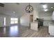 Open-concept living space with wood-look floors connecting the kitchen at 4237 Irdell Ter, North Port, FL 34288