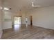 Spacious living room with wood-look tile flooring and vaulted ceilings at 4237 Irdell Ter, North Port, FL 34288