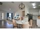 Open-concept living space with table and chairs with wood-look floors connecting the kitchen at 4237 Irdell Ter, North Port, FL 34288