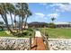 Beautiful landscaping and mature palms frame the home with a private dock and waterfront access at 4450 Northshore Dr, Punta Gorda, FL 33980