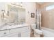 Bathroom featuring a vanity with a marble countertop, a sink, a large mirror, and a toilet next to a shower/tub at 4450 Northshore Dr, Punta Gorda, FL 33980