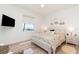Bright bedroom featuring a queen-size bed, a bedside table, a TV, and a window overlooking the lake at 4450 Northshore Dr, Punta Gorda, FL 33980