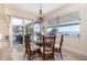 Dining room with water views, stylish lighting, and sliding glass door to outdoor living space at 4450 Northshore Dr, Punta Gorda, FL 33980