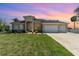 Well maintained single-story home with three-car garage and lush green lawn at 4450 Northshore Dr, Punta Gorda, FL 33980