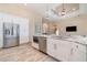 Modern kitchen boasts stainless steel appliances, white cabinetry and a marble countertop island at 4450 Northshore Dr, Punta Gorda, FL 33980