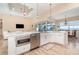 Open kitchen features white cabinets, stainless appliances and a marble countertop island with water view at 4450 Northshore Dr, Punta Gorda, FL 33980