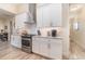 Contemporary kitchen features white cabinets, stainless steel appliances, marble counters and tile backsplash at 4450 Northshore Dr, Punta Gorda, FL 33980