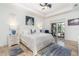 Bright main bedroom featuring tray ceiling, stylish decor, and sliding door access to lanai at 4450 Northshore Dr, Punta Gorda, FL 33980