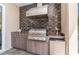 Outdoor kitchen with a built-in grill, a beverage refrigerator, a sink, and ample cabinet space at 4450 Northshore Dr, Punta Gorda, FL 33980