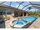 Relax in this screened-in pool and spa with an outdoor kitchen and plenty of seating areas at 4450 Northshore Dr, Punta Gorda, FL 33980